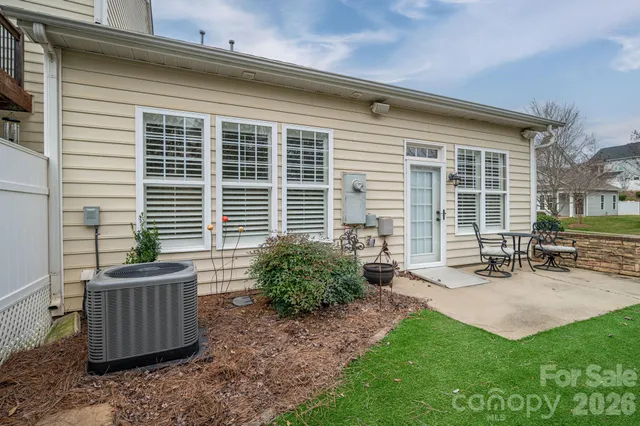 a front view of a house with outdoor seating and a garden