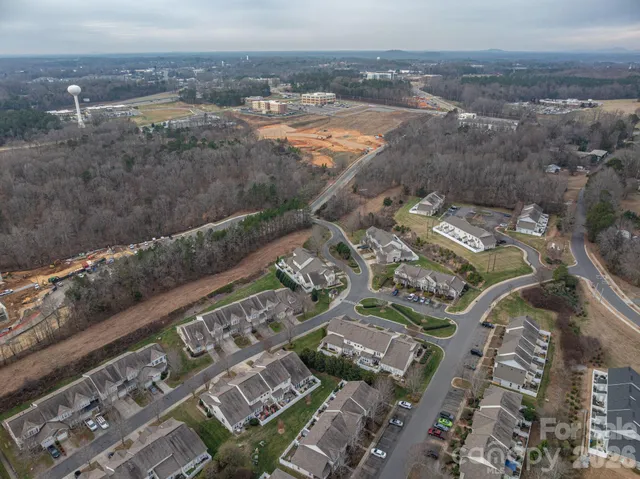 an aerial view of a house with a big yard and large trees