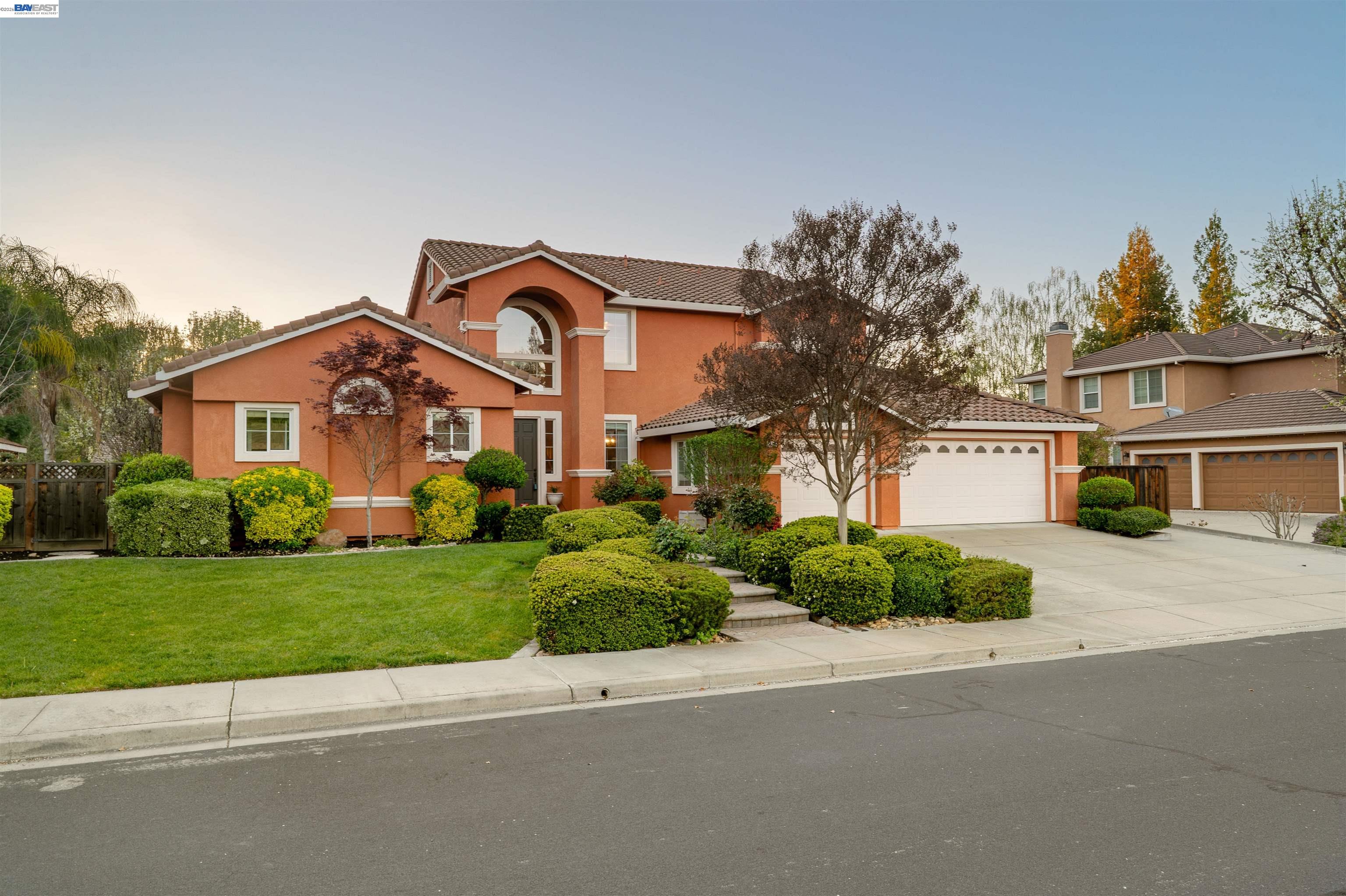 1635 Embassy Circle Livermore, CA 94550 - Photo 2 of 60 a front view of a house with a yard and a garage