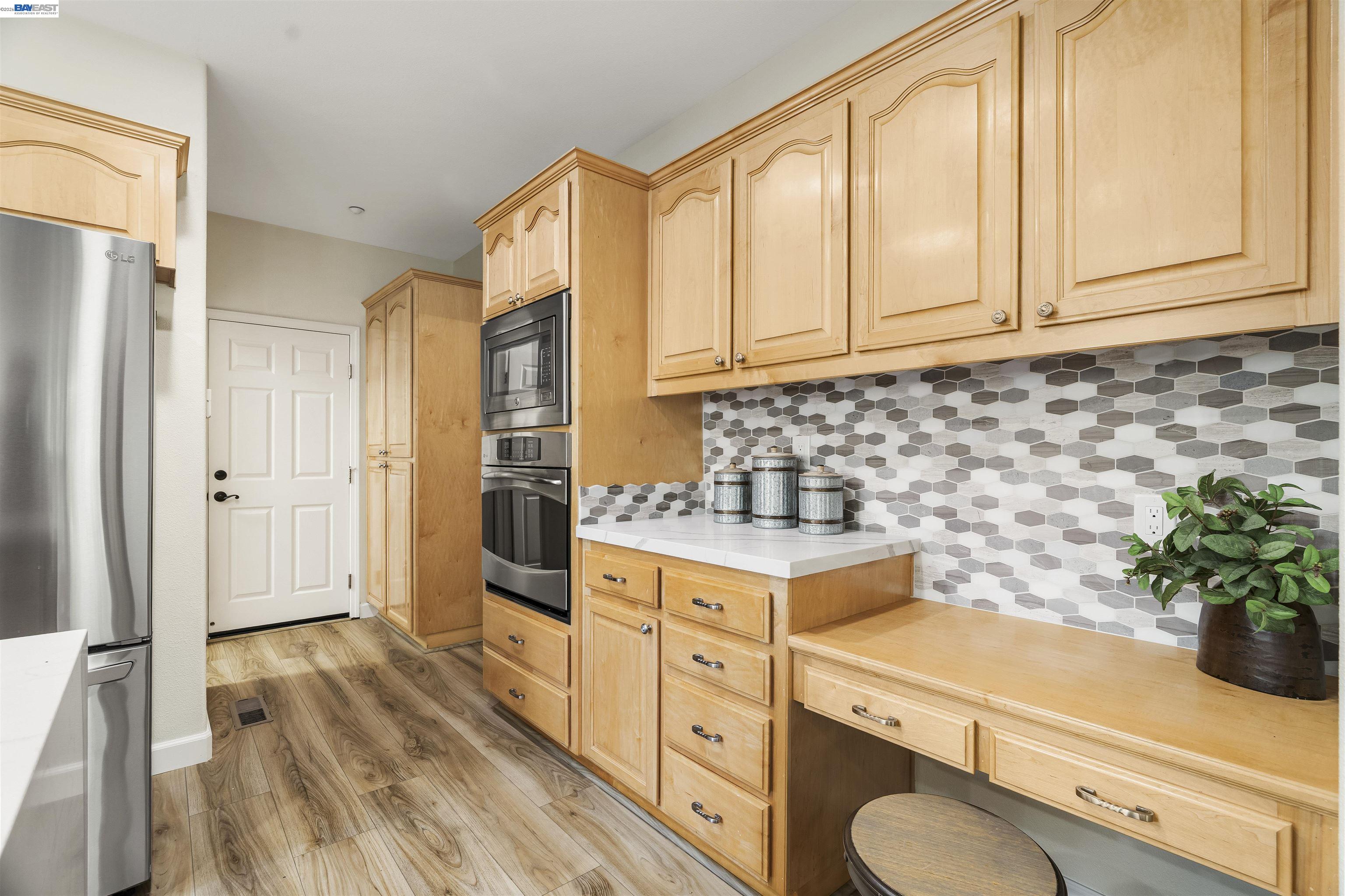 1635 Embassy Circle Livermore, CA 94550 - Photo 28 of 60 a kitchen with granite countertop white cabinets and white appliances