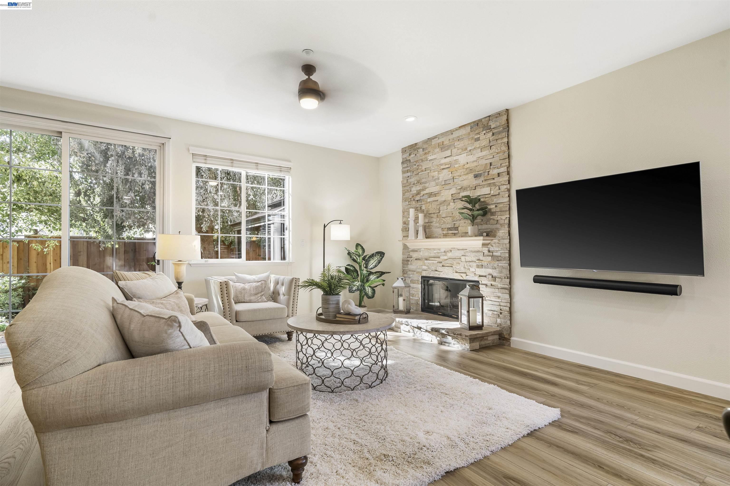 1635 Embassy Circle Livermore, CA 94550 - Photo 29 of 60 a living room with furniture floor to ceiling window hardwood floor and a flat screen tv
