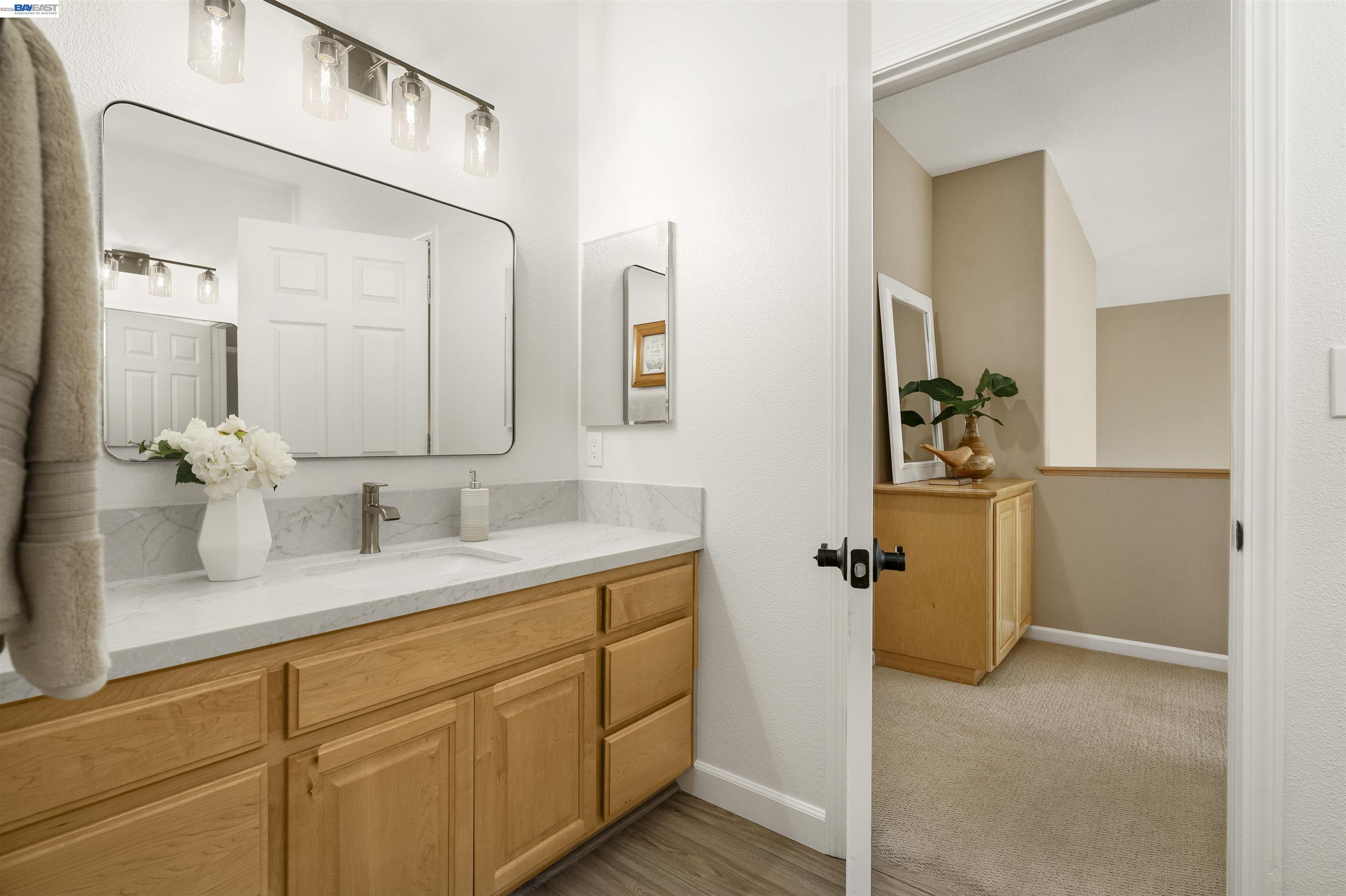 1635 Embassy Circle Livermore, CA 94550 - Photo 42 of 60 a bathroom with a granite countertop sink and a mirror