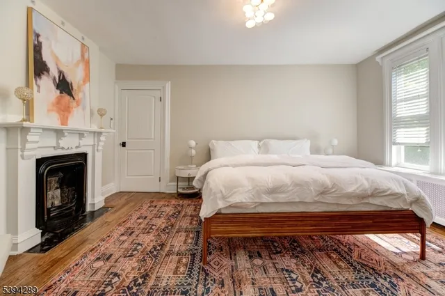 a bedroom with a bed and a fireplace