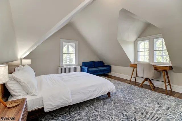 a bedroom with a bed chair and window