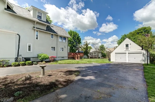 a view of a house with a yard and garage