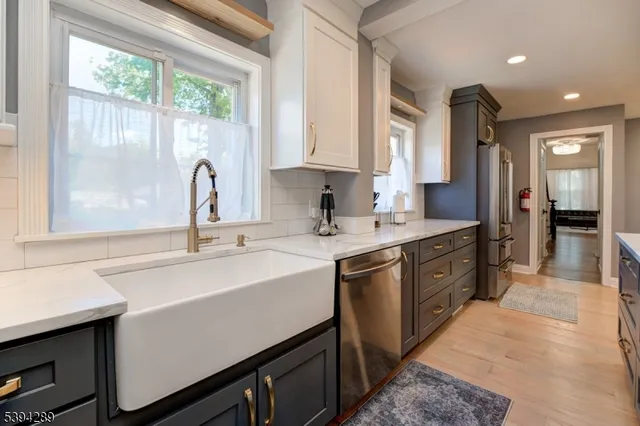 a kitchen with a sink stove and cabinets