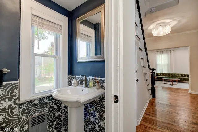 a bathroom with a sink a mirror and a window