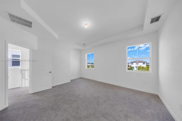 a view of an empty room and a window
