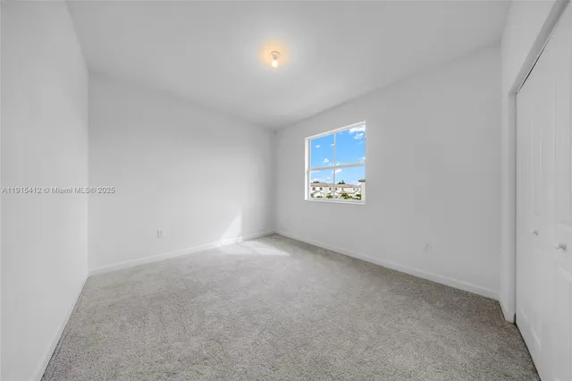 a view of an empty room and a window