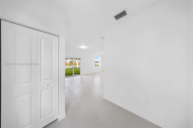 a view of hallway with wooden floor