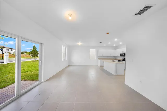 a view of a kitchen with a sink and a large window
