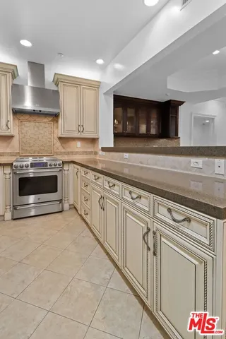 a stove top oven sitting inside of a kitchen