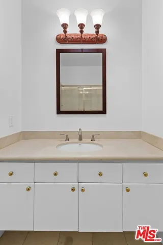 a view of a hallway with wooden floor and cabinet