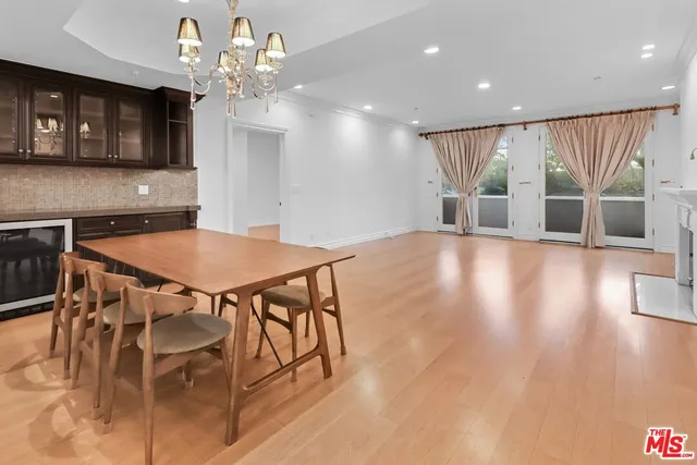 a view of kitchen and hall with wooden floor