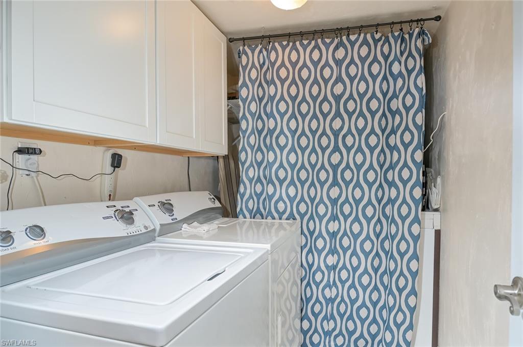 145 Cypress Way East, Unit A Naples, FL 34110 - Photo 19 of 24 a bathroom with a sink and a mirror