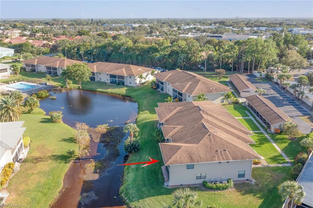 145 Cypress Way East, Unit A Naples, FL 34110 - Photo 23 of 24 an aerial view of residential houses with outdoor space