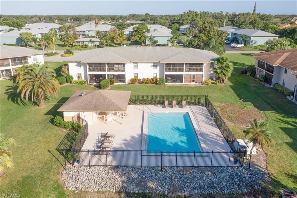 145 Cypress Way East, Unit A Naples, FL 34110 - Photo 24 of 24 an aerial view of multiple houses with a yard
