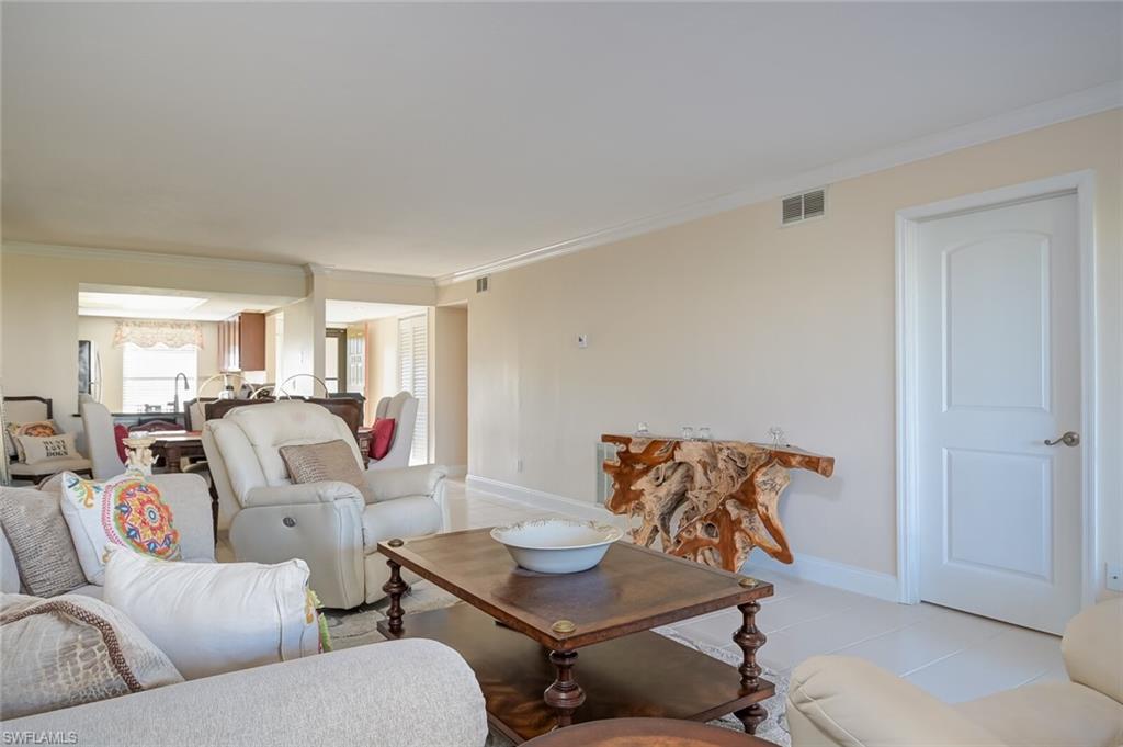145 Cypress Way East, Unit A Naples, FL 34110 - Photo 5 of 24 a living room with furniture and a window