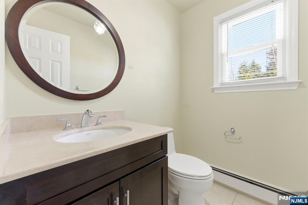 3 Rutgers Court Roseland, NJ 07068 - Photo 12 of 29 a bathroom with a sink a toilet and a mirror