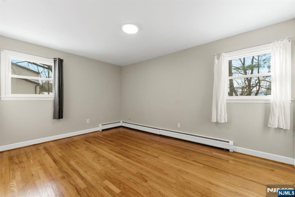 3 Rutgers Court Roseland, NJ 07068 - Photo 16 of 29 wooden floor in an empty room with a window