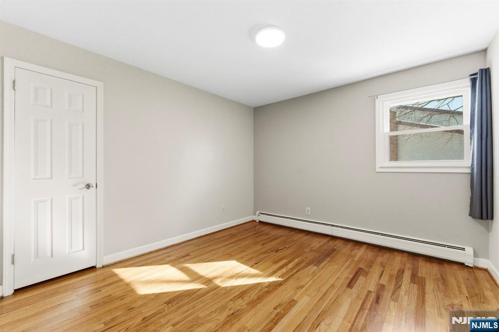 3 Rutgers Court Roseland, NJ 07068 - Photo 17 of 29 an empty room with wooden floor and windows