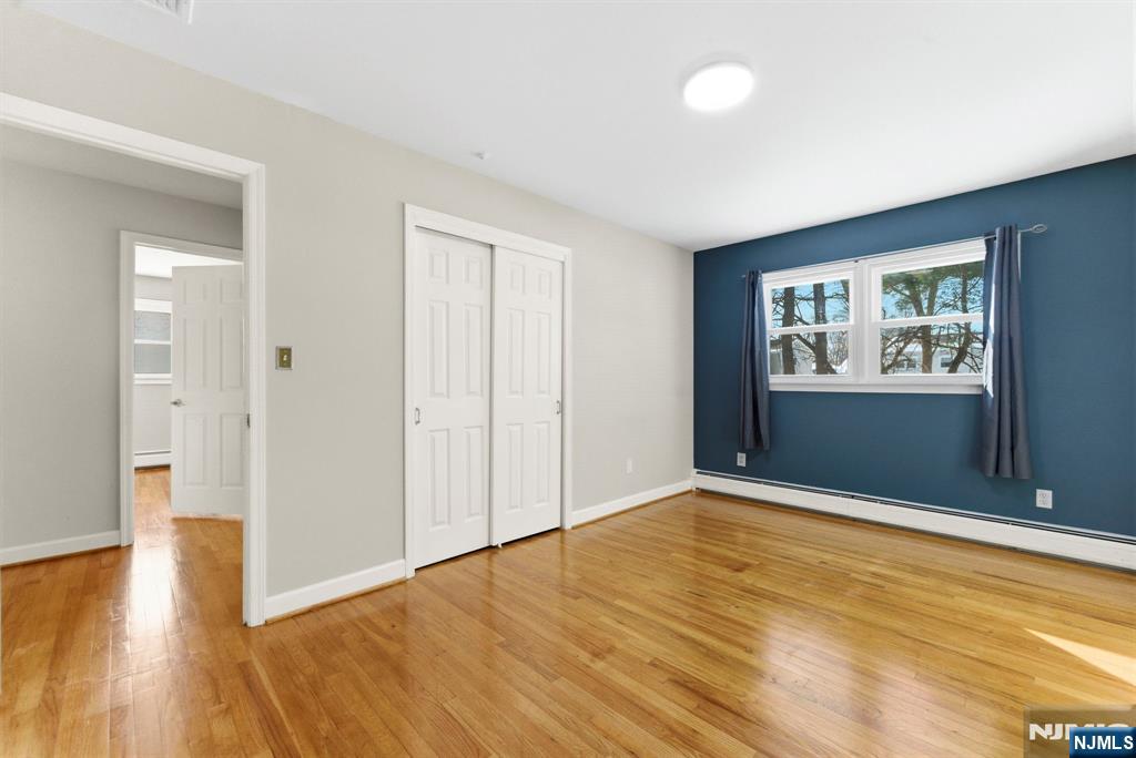 3 Rutgers Court Roseland, NJ 07068 - Photo 19 of 29 wooden floor in an empty room with a window
