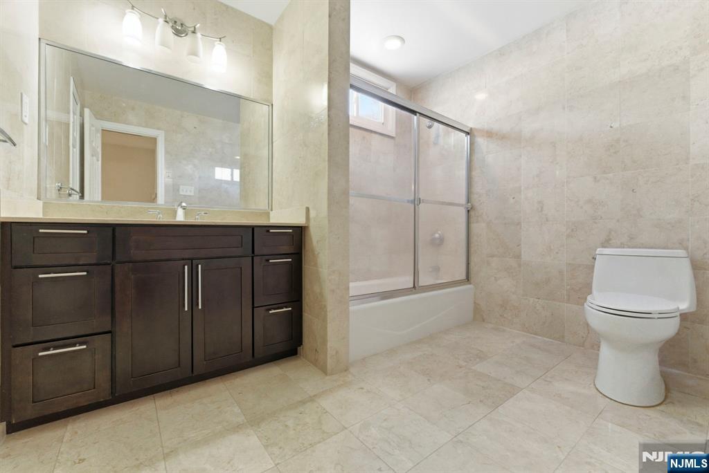 3 Rutgers Court Roseland, NJ 07068 - Photo 20 of 29 a bathroom with a toilet sink and mirror