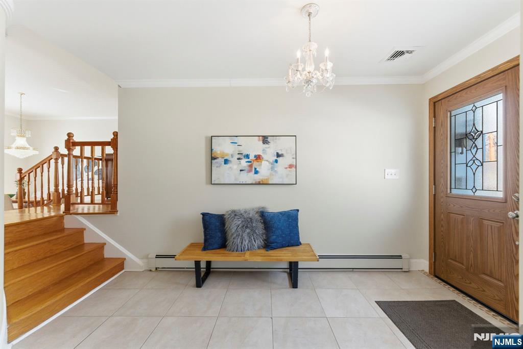 3 Rutgers Court Roseland, NJ 07068 - Photo 3 of 29 a spacious bedroom with a bed and a chandelier