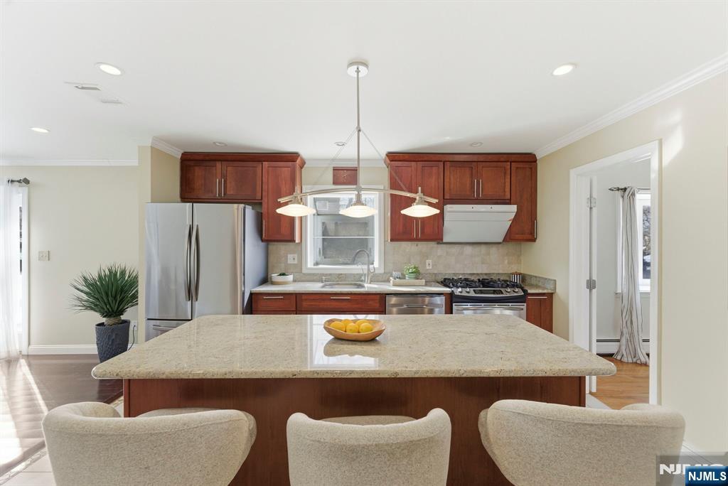 3 Rutgers Court Roseland, NJ 07068 - Photo 8 of 29 a kitchen with stainless steel appliances granite countertop a table and chairs