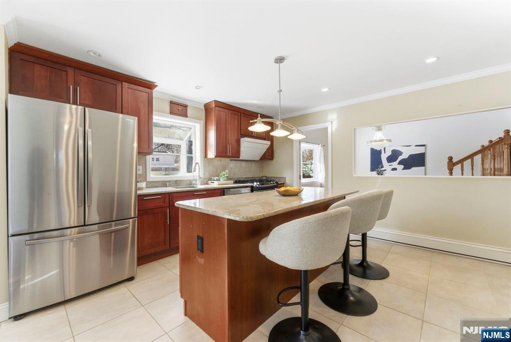 3 Rutgers Court Roseland, NJ 07068 - Photo 9 of 29 a kitchen with stainless steel appliances kitchen island granite countertop a refrigerator a sink and a stove