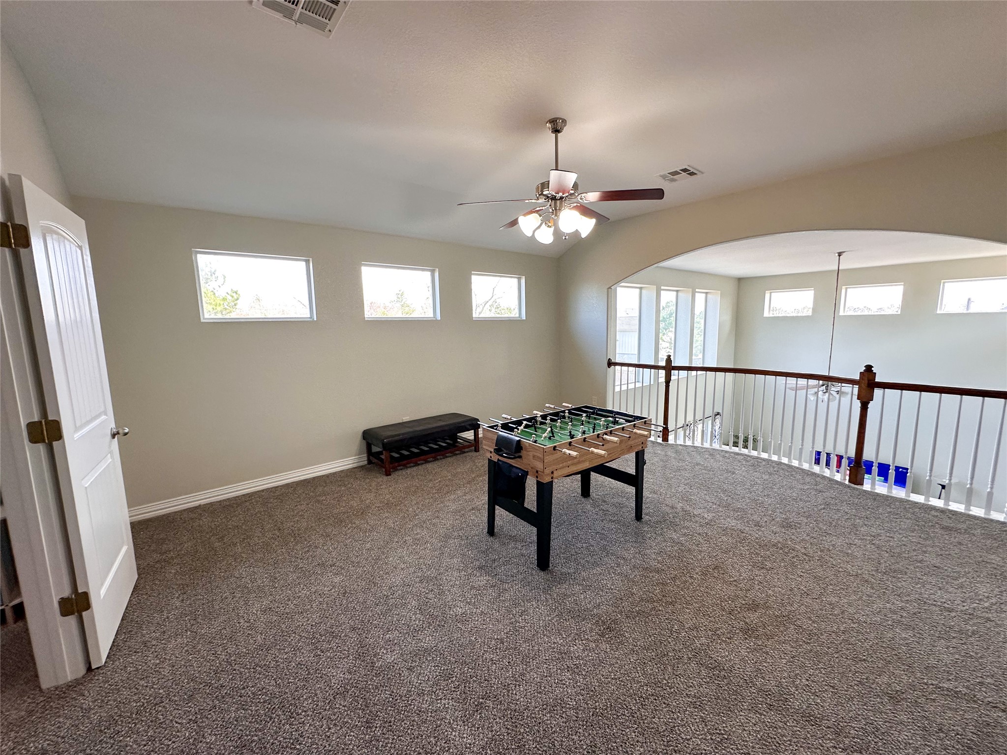 237 Cardinal Drive Paige, TX 78659 - Photo 21 of 37 Rec room with ceiling fan, carpet floors, and arched walkways
