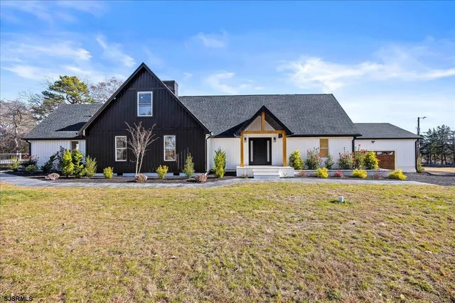 a front view of house with yard and seating area