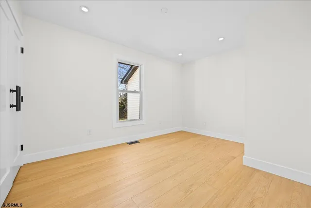 a view of a big room with windows and cabinet