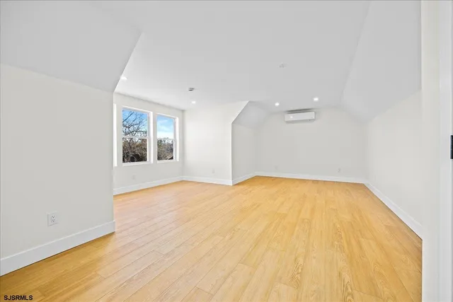 a view of a livingroom with wooden floor and white walls