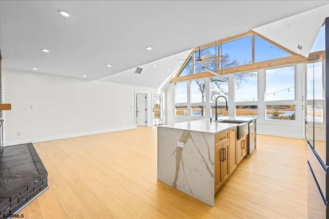 a large kitchen with stainless steel appliances kitchen island a large counter space a sink and a window