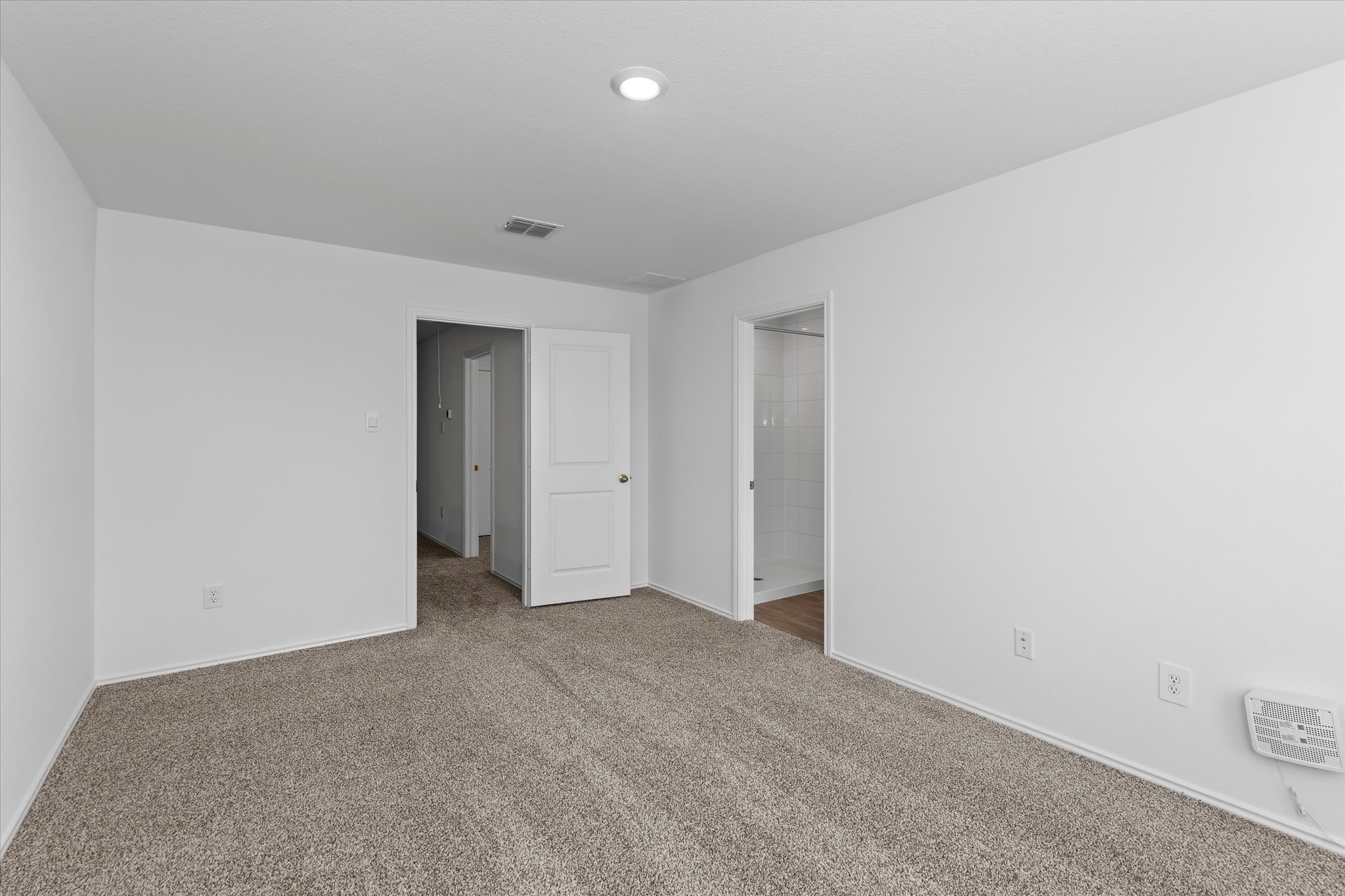 456 Sandringham Loop Kyle, TX 78640 - Photo 18 of 40 A spacious, neutral-toned room with plush carpet, ideal for relaxation.