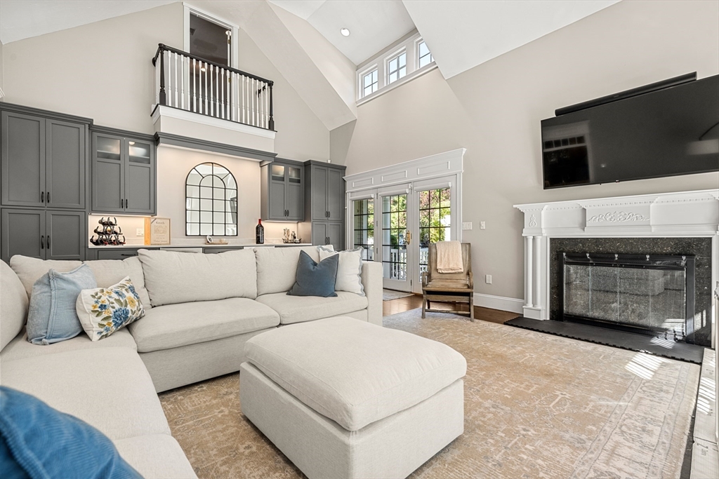 120 Deerfield Lane Hanover, MA 02339 - Photo 17 of 42 a living room with furniture a fireplace and a flat screen tv