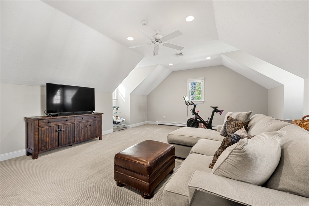 120 Deerfield Lane Hanover, MA 02339 - Photo 28 of 42 a living room with furniture and a flat screen tv