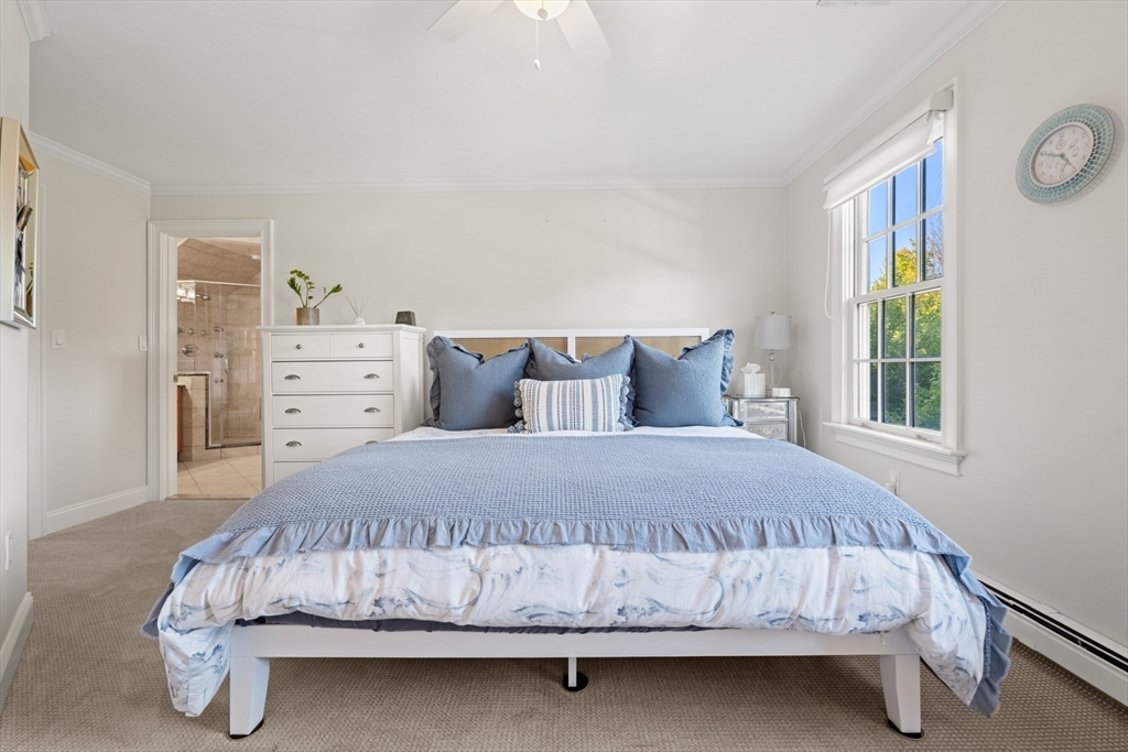 120 Deerfield Lane Hanover, MA 02339 - Photo 30 of 42 a bed sitting in a bedroom next to a window