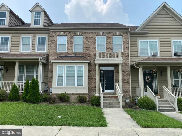 a front view of a brick house with a yard