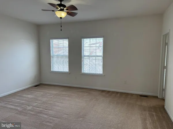 a view of room with window and ceiling fan