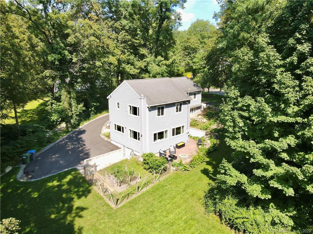 655 Monroe Turnpike Monroe, CT 06468 - Photo 1 of 1 a white house with a yard and large trees