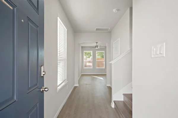 a view of hallway with wooden floor