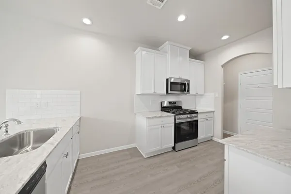 a kitchen with a sink and stainless steel appliances