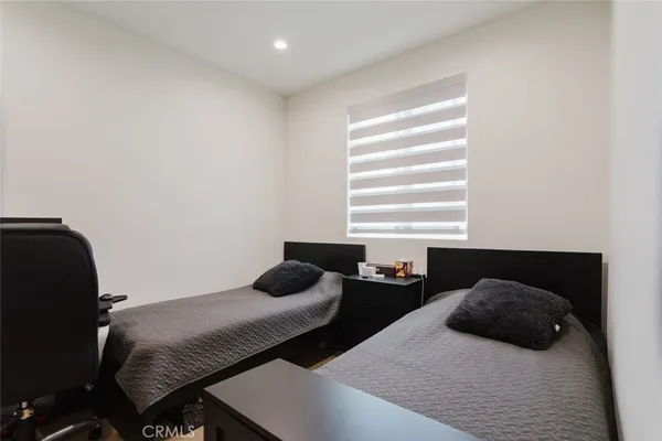 a bedroom with a bed and a television
