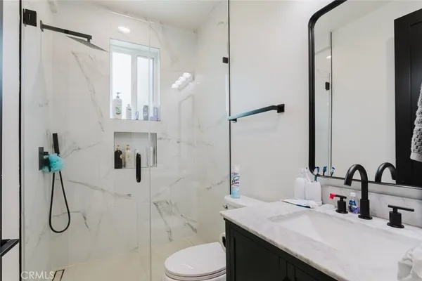 a bathroom with a sink toilet and shower