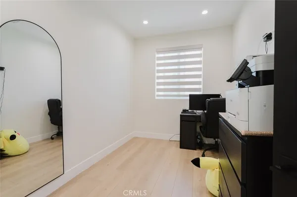 a bedroom with a bed and two windows