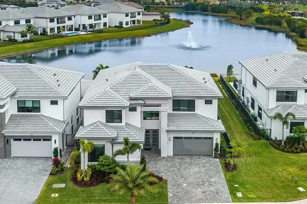 an aerial view of a house with swimming pool and outdoor seating