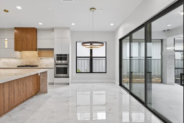 a view of an empty room with a chandelier