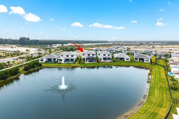a front view of a house with a garden and trees